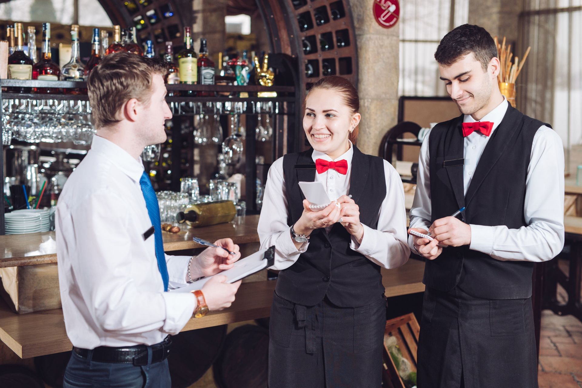 Manager's briefing with the waiters. Restaurant manager and his staff. 